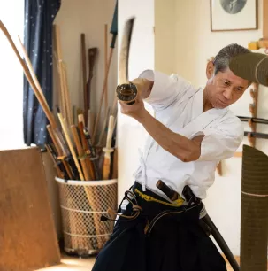 Samurai training under the guidance of an expert swordsman
